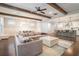 Open-concept living space with hardwood floors, beamed ceilings, and stylish furnishings at 1878 Weston Ln, Tucker, GA 30084