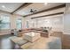 Open-concept living and dining area with wood beams, comfortable seating, and hardwood floors at 1878 Weston Ln, Tucker, GA 30084