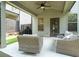 Covered patio with outdoor seating, ceiling fan, and access to a fenced backyard at 1878 Weston Ln, Tucker, GA 30084
