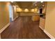 Basement featuring a kitchenette, bar, and hardwood floors at 5014 Dovecote Trl, Suwanee, GA 30024