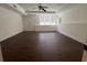 Basement featuring a large window, a ceiling fan, and hardwood floors at 5014 Dovecote Trl, Suwanee, GA 30024