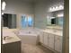 Bathroom with dual sinks, a soaking tub, and a separate shower at 5014 Dovecote Trl, Suwanee, GA 30024