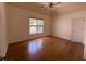Bright bedroom featuring hardwood floors and a large window at 5014 Dovecote Trl, Suwanee, GA 30024