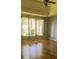 A main bedroom featuring a tray ceiling and large windows at 5014 Dovecote Trl, Suwanee, GA 30024