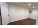 A clean, unfurnished room with dark hardwood floors provides a versatile space ready for personalization at 5014 Dovecote Trl, Suwanee, GA 30024