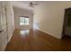 Bedroom with hardwood floors, a ceiling fan, and a window at 5014 Dovecote Trl, Suwanee, GA 30024