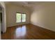 A primary bedroom with a ceiling fan, hard wood floors, and large windows at 5014 Dovecote Trl, Suwanee, GA 30024
