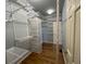 Walk-in closet with custom shelving and ample storage space at 5014 Dovecote Trl, Suwanee, GA 30024