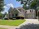 Charming two-story home with a well-manicured lawn and attached two car garage at 5014 Dovecote Trl, Suwanee, GA 30024