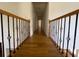 Hallway featuring hardwood floors and a decorative banister at 5014 Dovecote Trl, Suwanee, GA 30024