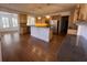 Open kitchen with island, pendant lights, and stainless steel appliances at 5014 Dovecote Trl, Suwanee, GA 30024