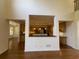 An open-concept kitchen with stainless steel appliances, island, and hardwood flooring at 5014 Dovecote Trl, Suwanee, GA 30024