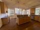 Open kitchen with granite countertops, stainless steel appliances, and a large island at 5014 Dovecote Trl, Suwanee, GA 30024