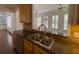 This kitchen has stainless steel appliances and bar seating that overlooks the living area at 5014 Dovecote Trl, Suwanee, GA 30024