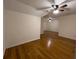 Open living room featuring hardwood floors and a ceiling fan at 5014 Dovecote Trl, Suwanee, GA 30024