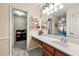 Bathroom vanity with large countertop, vanity mirror, and door to a closet at 5018 Old Ivy Rd, Peachtree Corners, GA 30096