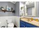 Bathroom features gray walls, a vanity with sink, a toilet, and decor shelves at 5018 Old Ivy Rd, Peachtree Corners, GA 30096
