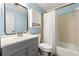 Bathroom features a tub with shower, vanity, and blue walls at 5018 Old Ivy Rd, Peachtree Corners, GA 30096