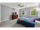 Bedroom with a TV, a ceiling fan, and two windows with natural light at 5018 Old Ivy Rd, Peachtree Corners, GA 30096