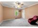 Bedroom with a ceiling fan, large window, and sitting chair at 5018 Old Ivy Rd, Peachtree Corners, GA 30096