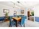 Dining room features blue and white walls with decor, a wooden table, and a view into the living room at 5018 Old Ivy Rd, Peachtree Corners, GA 30096