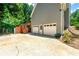 Rear exterior with three-car garage, stairway, and driveway at 5018 Old Ivy Rd, Peachtree Corners, GA 30096