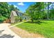 Exterior of two-story home featuring a front yard and a three-car garage at 5018 Old Ivy Rd, Peachtree Corners, GA 30096