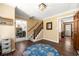Welcoming foyer with hardwood floors, staircase, and views into the dining room at 5018 Old Ivy Rd, Peachtree Corners, GA 30096
