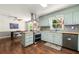 Bright kitchen featuring stainless steel appliances, painted cabinets, and hardwood flooring at 5018 Old Ivy Rd, Peachtree Corners, GA 30096