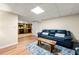 Cozy living area featuring a blue couch, wood flooring, and a rustic coffee table at 5018 Old Ivy Rd, Peachtree Corners, GA 30096