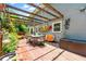 Outdoor patio with wood pergola, dining set, surfboard decoration, and lush plants at 5018 Old Ivy Rd, Peachtree Corners, GA 30096