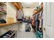 Walk-in closet with built-in wooden shelves and storage for clothing and accessories at 5018 Old Ivy Rd, Peachtree Corners, GA 30096