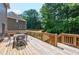 Wooden back deck with outdoor seating overlooking a lush backyard at 672 Red Sunset Cir, Powder Springs, GA 30127