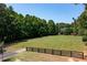 Large backyard with fence and view of house, perfect for outdoor activities at 672 Red Sunset Cir, Powder Springs, GA 30127