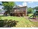 Expansive backyard with a playset, a deck, and steps, perfect for outdoor activities and relaxation at 672 Red Sunset Cir, Powder Springs, GA 30127