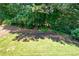 Lush backyard with mature trees and an expansive lawn at 672 Red Sunset Cir, Powder Springs, GA 30127