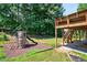 Backyard featuring a playground and upper level porch with stairs at 672 Red Sunset Cir, Powder Springs, GA 30127
