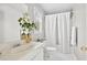 Bright bathroom with a white vanity, decorative touches and a shower with a white curtain at 672 Red Sunset Cir, Powder Springs, GA 30127