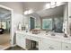 Bathroom with double vanity, tile floors, and a doorway leading to the bedroom at 672 Red Sunset Cir, Powder Springs, GA 30127