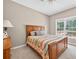 Cozy bedroom featuring carpet, a wooden bed frame, and a window with natural light at 672 Red Sunset Cir, Powder Springs, GA 30127