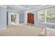 Spacious bedroom with carpet, a wooden dresser, and large windows at 672 Red Sunset Cir, Powder Springs, GA 30127