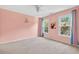 Spacious carpeted bedroom featuring two windows providing natural light and nice views at 672 Red Sunset Cir, Powder Springs, GA 30127