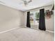 Bedroom with neutral carpet and walls features a large window with black out curtains at 672 Red Sunset Cir, Powder Springs, GA 30127