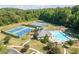 Aerial view of community pool and tennis courts, a great amenity for active residents and social gatherings at 672 Red Sunset Cir, Powder Springs, GA 30127
