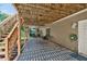 Covered back patio with stairs to a wooden deck above and an exterior door leading into the home at 672 Red Sunset Cir, Powder Springs, GA 30127