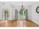 Formal dining room featuring hardwood floors, wainscoting, and an elegant chandelier at 672 Red Sunset Cir, Powder Springs, GA 30127