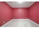 Empty room with neutral carpet, crisp white trim, and painted red walls at 672 Red Sunset Cir, Powder Springs, GA 30127