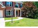 Well-manicured front yard with lush green lawn and a curved walkway leading to the entrance at 672 Red Sunset Cir, Powder Springs, GA 30127