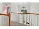 Hallway overlooking the foyer featuring a wooden railing and natural light at 672 Red Sunset Cir, Powder Springs, GA 30127