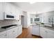 Bright kitchen features granite countertops, white cabinets, and stainless steel appliances at 672 Red Sunset Cir, Powder Springs, GA 30127